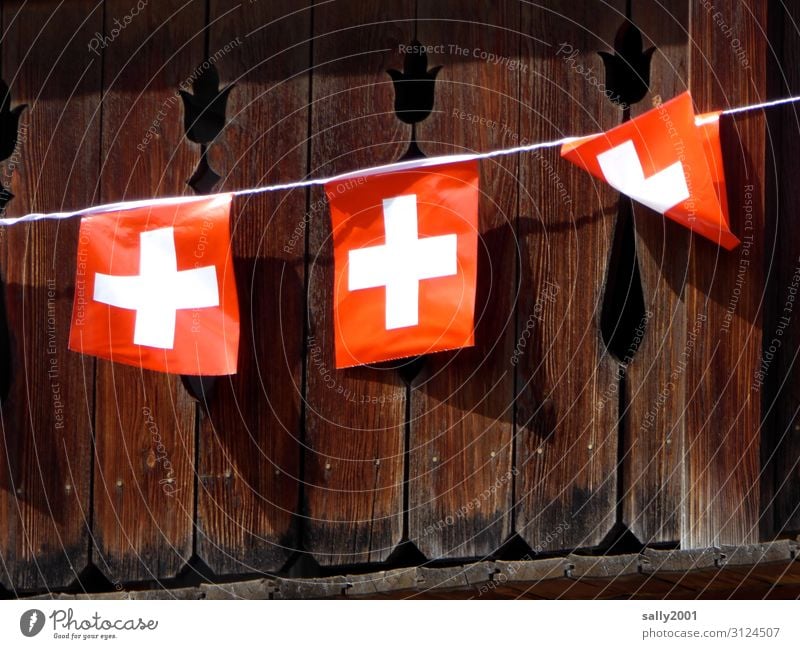 Flags in the wind... Wind Switzerland Swiss flag Hut Balcony Tourism Ensign Symbols and metaphors Rope fold Blown away Flying the flag Gust of wind Colour photo