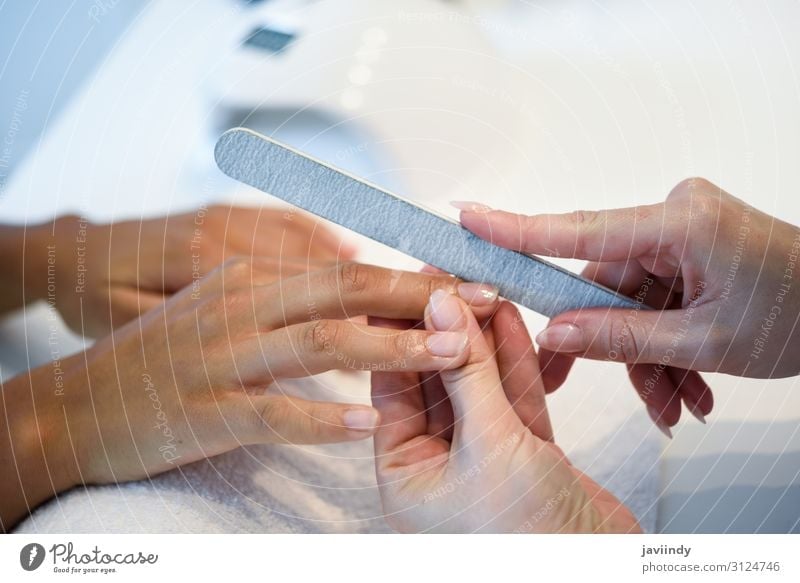 Woman in a nails salon receiving a manicure with nail file Beautiful Skin Manicure Medical treatment Wellness Spa Human being Feminine Adults Hand Fingers 2
