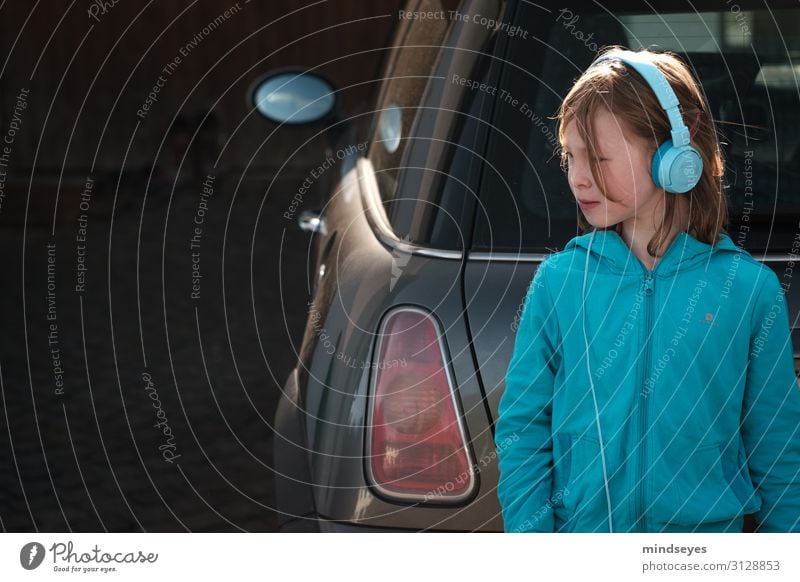 Girl with headphones leaning on car Listen to music MP3 player Headphones Feminine Infancy 1 Human being 3 - 8 years Child Car Small car Jacket Blonde Mirror