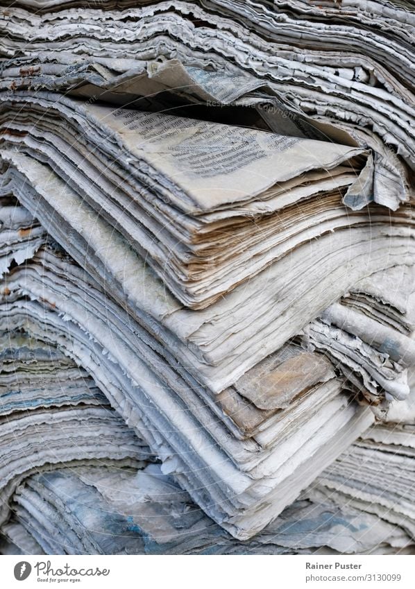 Piles of wet newspapers and books Media industry Advertising Industry Paper Book Newspaper Characters Wet Soft Gray White Past Transience Colour photo