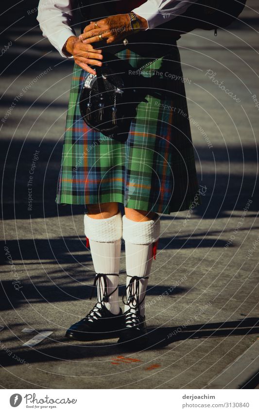 Bagpipe player on the street. You can't see the head of the player. Playing Trip Fairs & Carnivals Piper Sporting Complex Masculine Fingers Legs Feet 1