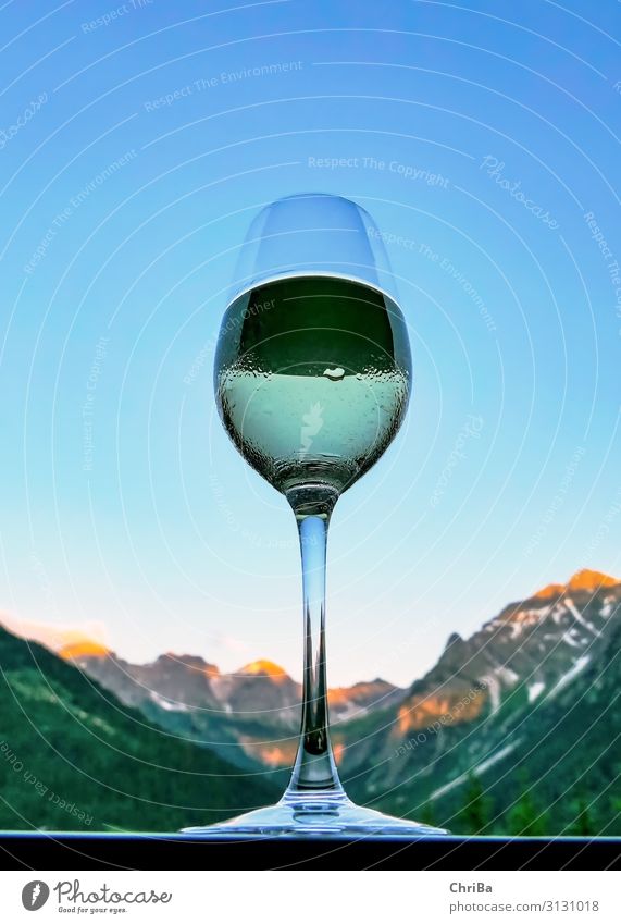 A glass of white wine at sunset on the balcony with a view of the Alps Beverage Vine Glass Lifestyle Luxury Elegant Relaxation Vacation & Travel Tourism Freedom