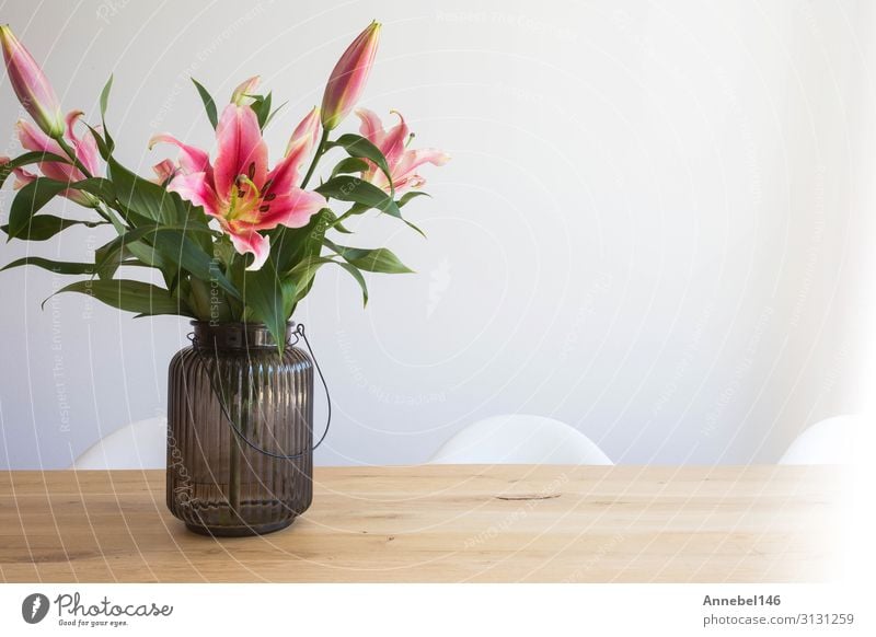 pink lily flowers in a vase on a wooden table Elegant Design Beautiful Summer Flat (apartment) Garden Decoration Table Nature Plant Flower Leaf Blossom