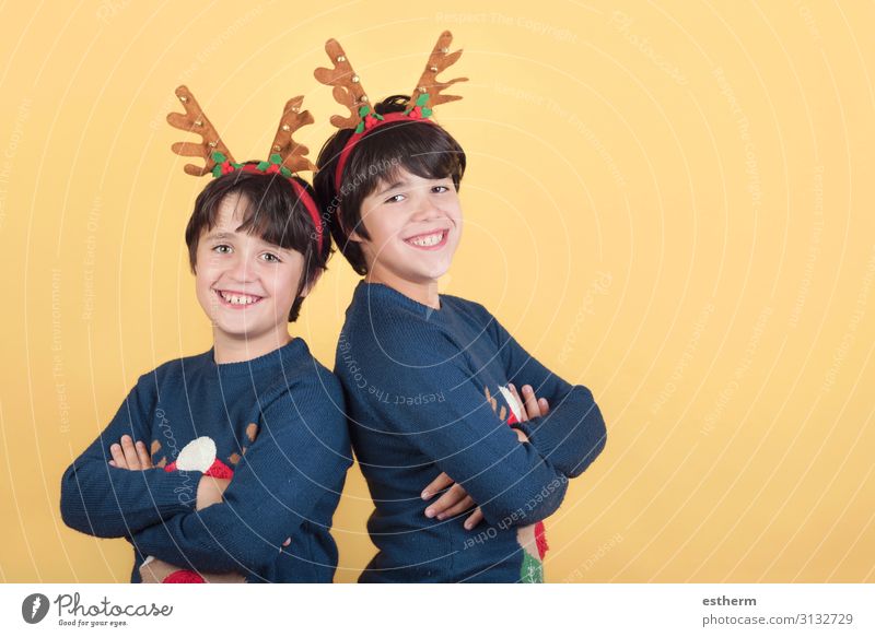 smiling children in a Rudolph Reindeer christmas costume on yellow background Joy Winter Feasts & Celebrations Christmas & Advent New Year's Eve Human being