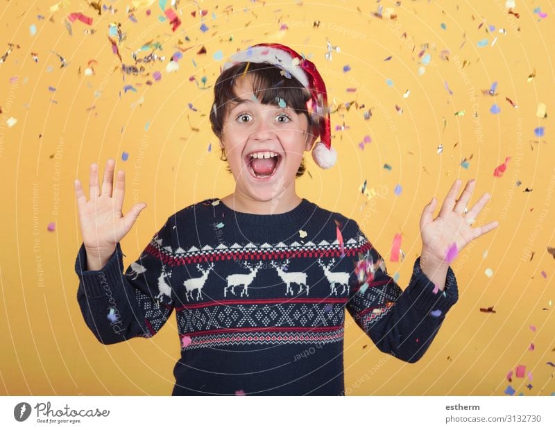 smiling child with confetti Wearing Christmas Santa Claus Hat Joy Winter Feasts & Celebrations Christmas & Advent New Year's Eve Human being Masculine Child