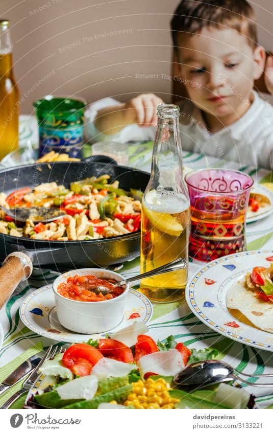Pan with mexican food on a table Vegetable Eating Dinner Beer Table Restaurant Child Human being Boy (child) Man Adults Group To enjoy Authentic Hot Delicious