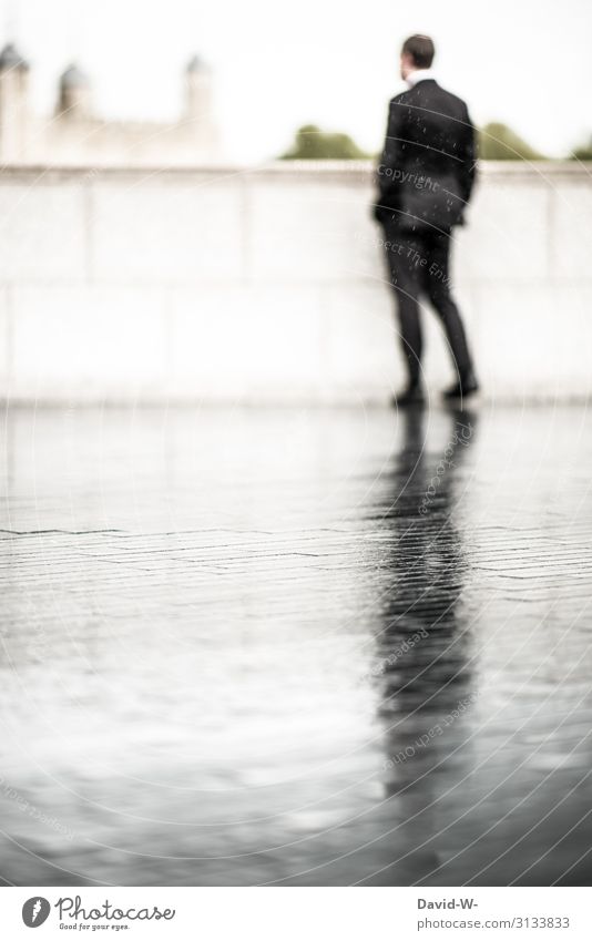 Man with suit stands in the rain suit-wearer Suit Rain Rainy weather Business Bad weather Shadow reflection Dark side Shadowy existence shadow cast