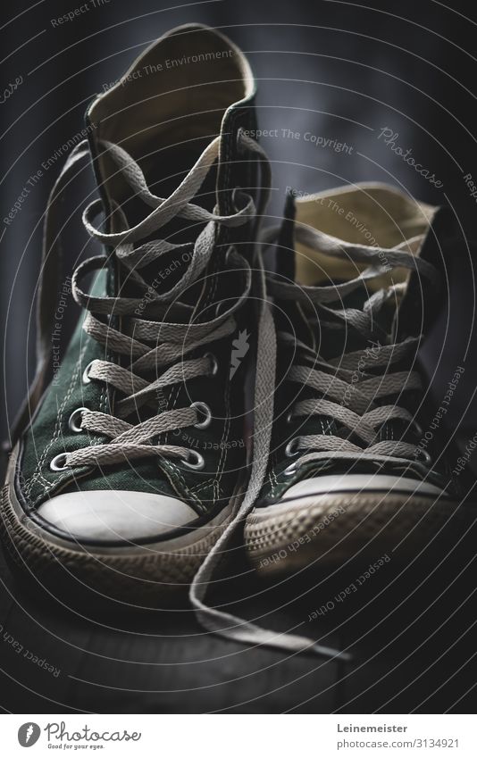 Worn sneakers Old Footwear Second-hand utilised bokeh shoelaces Green Modern Fashion Sports Athletic Dark Design trend Walking blurred Iconic popular youthful
