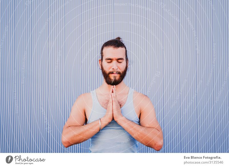 man in the city practicing yoga sport. blue background. healthy lifestyle Blue background Yoga Man City Town Lifestyle Muscular Concentrate Position Human being
