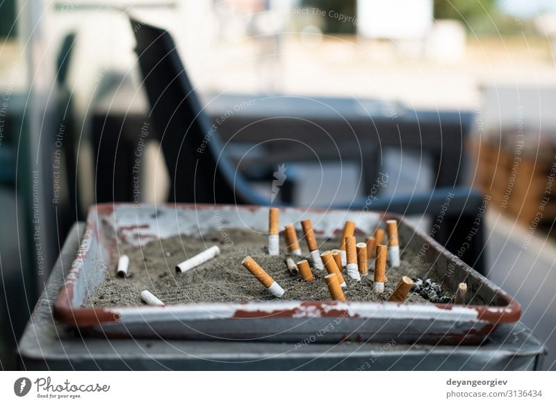 Ashtray with sand and buried cigarettes. Sand Dirty Cigarette Butt smoking area Conceptual design Public stop Cancer Ashes filter health smoke Lung Trash