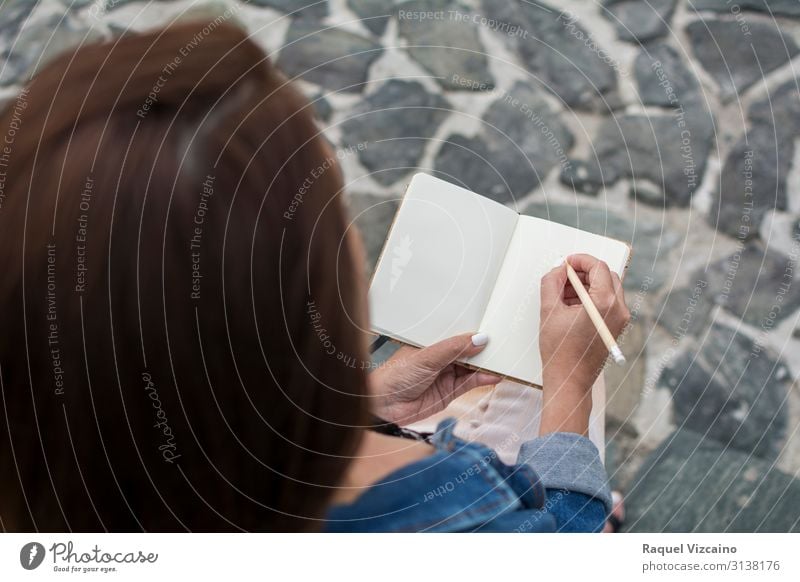 Woman holding a blank notebook. Lifestyle Reading Education Adult Education Human being Adults 18 - 30 years Youth (Young adults) Book Write Sit Beginning Blank