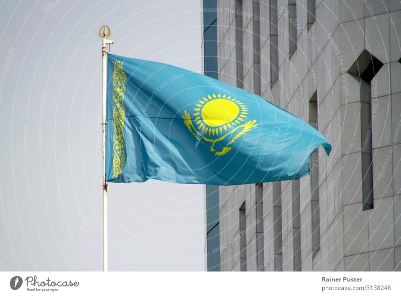 National flag of Kazakhstan in the wind almaty astana nur-sultan Town Downtown Flag Ensign Blue Yellow Gray Attachment Nationalities and ethnicity Colour photo