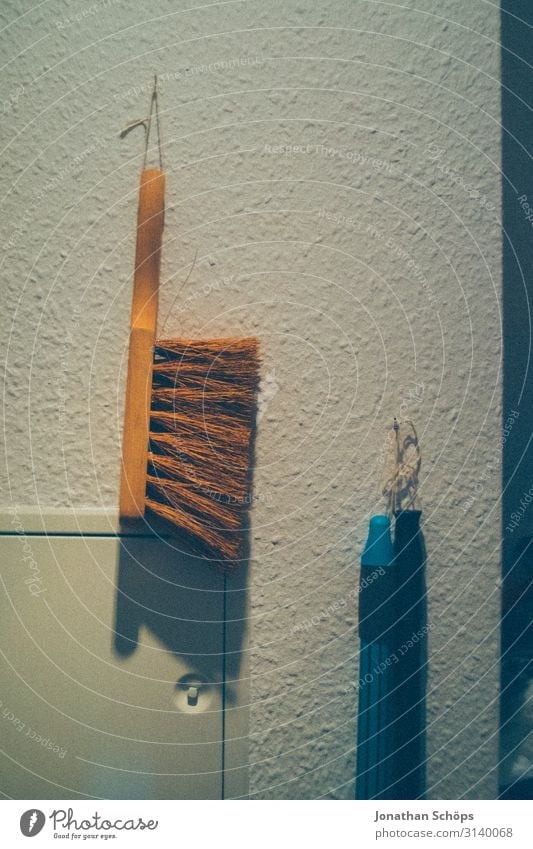Hand brushes to sweep and broom handle hanging on the wall in a storage room hand brush Broom Sweep Clean Cleaning Dirty Deserted Colour photo