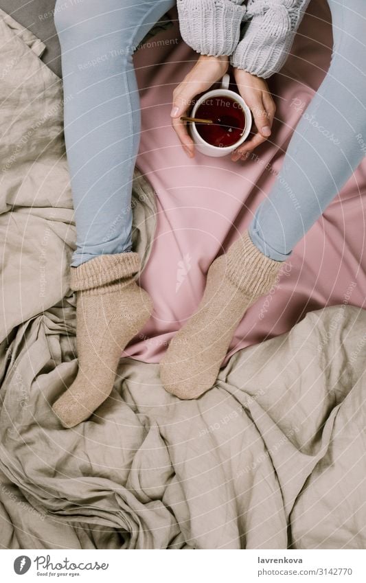 Cozy flatlay of woman's legs in blue leggins and warm socks Autumn Bedroom Beverage Blanket Duvet Clothing Cold Safety (feeling of) Cup Faceless Woman flat lay