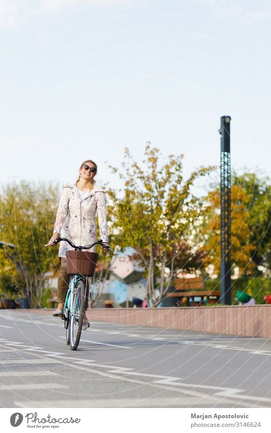 Young woman riding a bicycle in the city Joy Athletic Life Cycling Bicycle Feminine Youth (Young adults) Woman Adults 1 Human being 30 - 45 years Town Transport