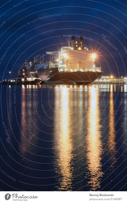 Illuminated ship in a port at night. Ocean Waves Industry Logistics Business Harbour Transport Navigation Oil tanker Watercraft Large LNG tanker LNG carrier