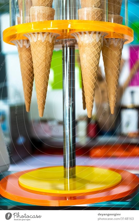 Waffle cones for ice cream put on stand. Ice cream shop. Dessert Summer Cool (slang) Fresh Delicious Yellow food cold crispy Scoop flavor Snack sweet