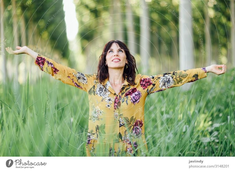 Young woman arms raised enjoying the fresh air in green forest Lifestyle Happy Beautiful Relaxation Leisure and hobbies Vacation & Travel Adventure Freedom