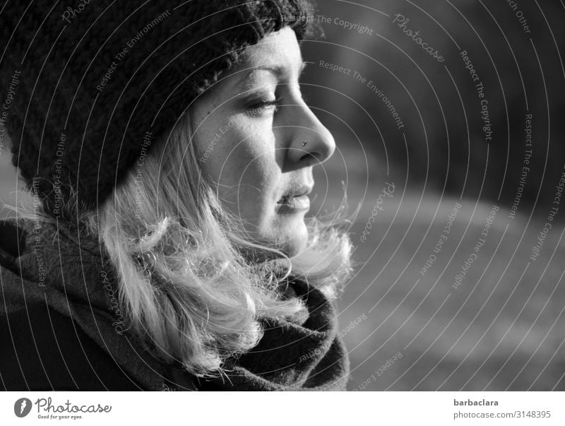 Enjoying the winter sun Woman Adults 1 Human being Nature Landscape Winter Beautiful weather Meadow Forest Scarf Cap Blonde To enjoy Bright Cold Warmth Emotions