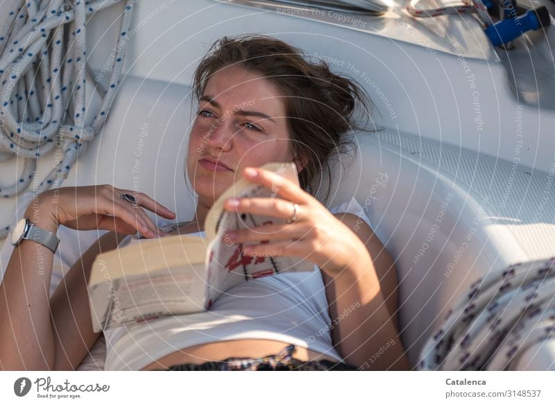 Written | to think about; Thoughtfully the young woman looks up from her book Reading Sailing Feminine Young woman Youth (Young adults) 1 Human being Yacht