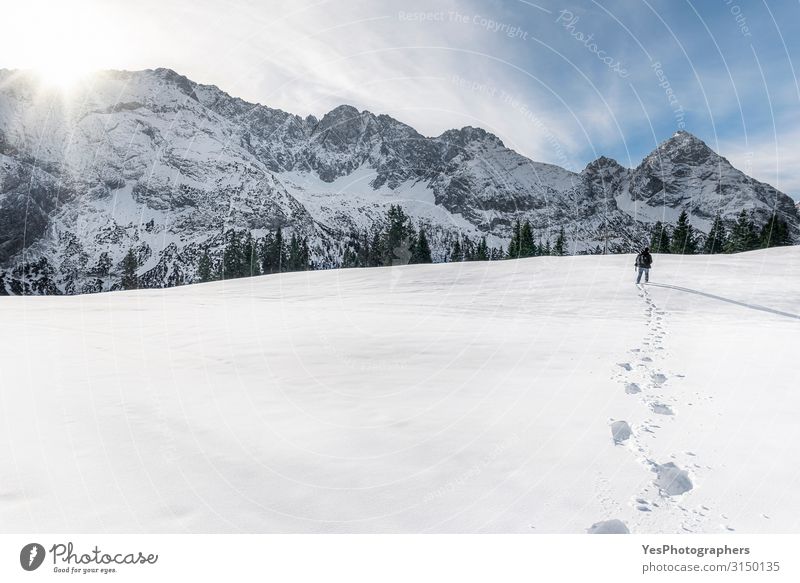 Winter mountains and man walking through snow. Footsteps in snow Adventure Snow Mountain Hiking Man Adults 1 Human being Nature Landscape Sun Climate change