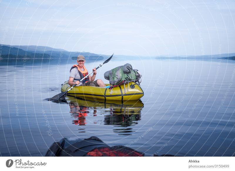 Young man in kayak on a windless lake boat Canoe Paddling Blue Lake equilibrium Calm Adventure Canoe trip Testing & Control Authentic Vacation & Travel Freedom