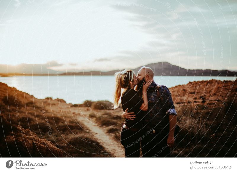 Couple kissing at sunset by the sea Future Together Attachment social distancing fortunate Funny in common Laughter heartfelt Contrast Rich in contrast Feminine