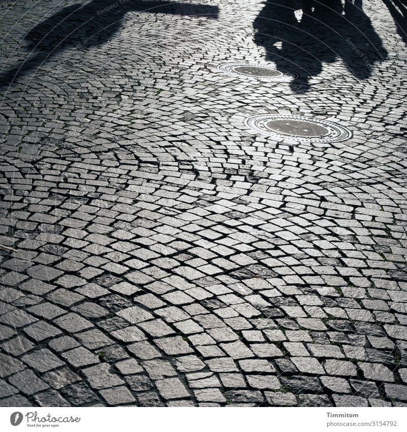 Square with shaders Shadow location people Stone Light Paving stone Outdoors stroll Exterior shot Cobblestones Places Floor covering lines light and dark