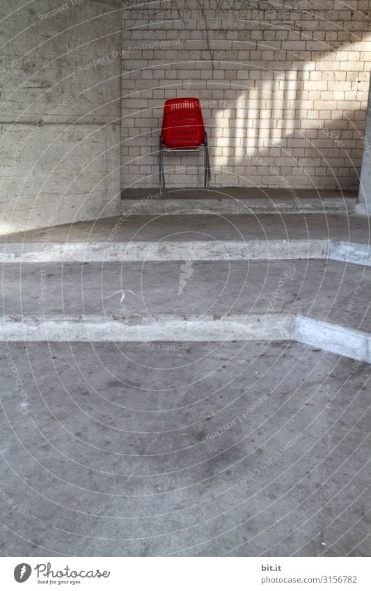 Red plastic chair, with light in front of the wall. Manmade structures Building Architecture Wall (barrier) Wall (building) Stairs Facade Stone Concrete Line