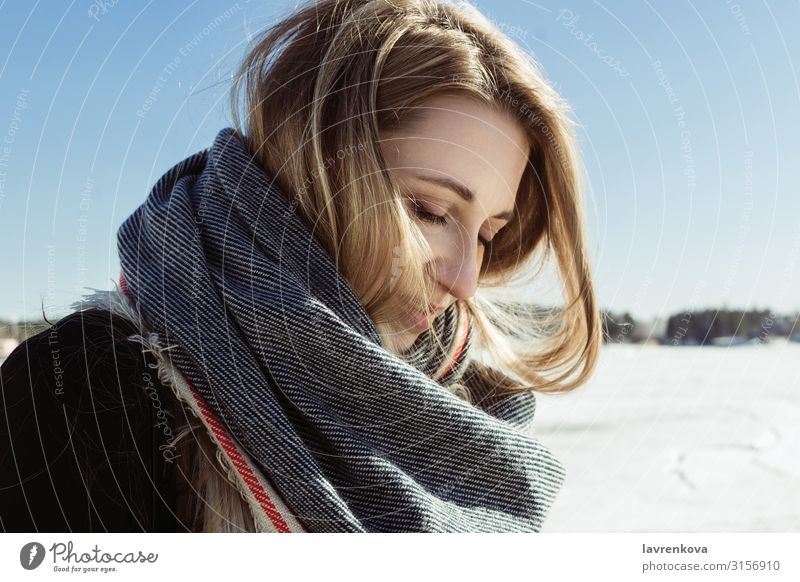 Closeup portrait of white female in a scarf on a frozen river Autumn Blonde Caucasian Coat Cold Face Young woman Hair Lifestyle Nature Exterior shot