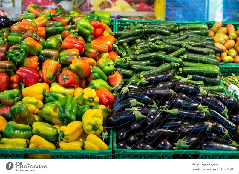 Arranged eggplants, peppers and zucchini. Food Vegetable Shopping Marketplace Stand Sell Supermarket Zucchini assortment Heap shelfs Variety Product