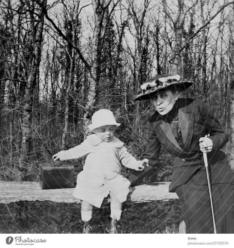 ready to leave Masculine Feminine Child Woman Adults Grandmother 2 Human being Beautiful weather Forest Dress Suitcase Walking stick Hat Bench Observe