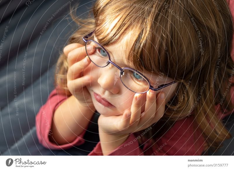 Young blue eyed girl with eye glasses looking into the light Beautiful Child Baby Infancy Eyes Eyeglasses Blonde Think Small Cute Blue Concentrate Innocent