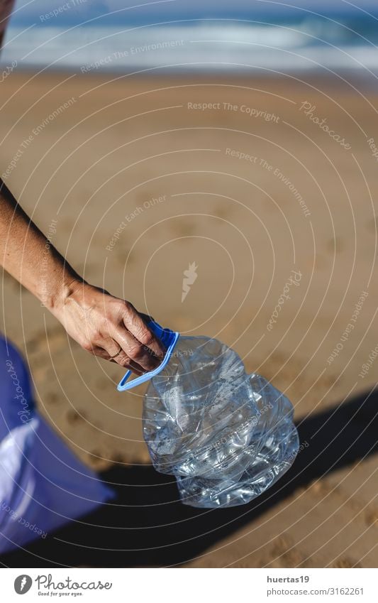 Woman picking up trash and plastics cleaning the beach Bottle Lifestyle Beach Ocean Adults Hand Environment Nature Sand Coast Dog Package Plastic Sustainability