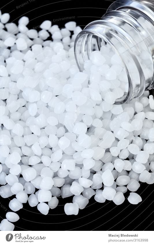 Close up picture of polypropylene (PP) granules. Industry Technology Plastic White polypropene thermoplastic polymer Pellet Particle black background