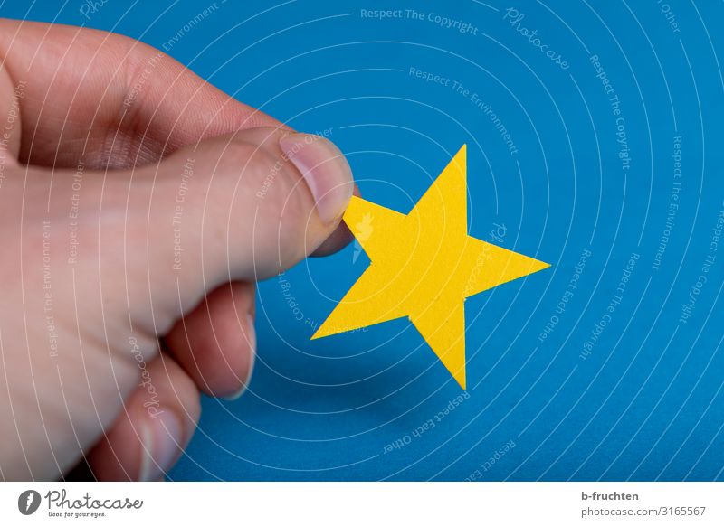 yellow star on blue background Office Economy Business Career Success Fingers Paper Decoration Sign Flag Work and employment Select Touch Movement To hold on