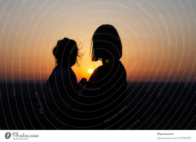 Mother and daughter who sit and look at the sunset . Joy Beautiful Vacation & Travel Freedom Summer Sun Ocean Child Baby Toddler Woman Adults Parents