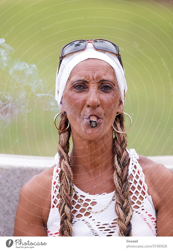 Cuban woman smoking a cigar in a park in Havana , Cuba Lifestyle Style Playing Vacation & Travel Trip Island Human being Feminine Woman Adults Female senior