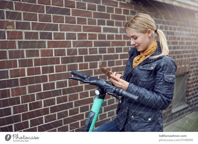 Trendy young blond woman booking e-scooter Face Reading PDA Technology Woman Adults 1 Human being 18 - 30 years Youth (Young adults) Environment Transport
