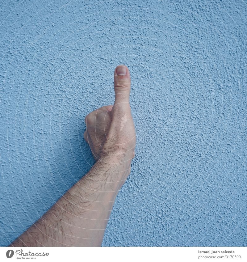 hand gesturing ok on the blue wall Hand Wall (building) Blue Fingers Palm of the hand Body wrist Arm Skin Human being Gesture Conceptual design