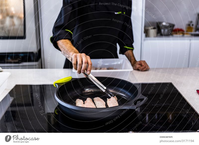 Chef frying a bass on a restaurant Food Meat Fish Seafood Eating Lunch Dinner Diet Pan Spoon Lifestyle Table Kitchen Restaurant Feasts & Celebrations Teacher