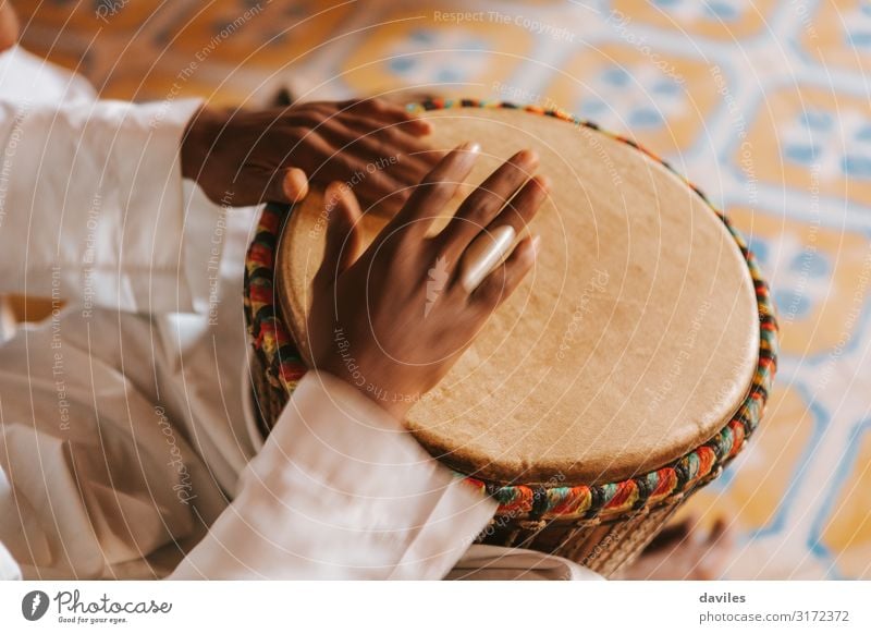 Man playing djembe in Morocco, Africa. Exotic Entertainment Music Craft (trade) Rope Human being Hand 1 Art Culture Musician Drum set Wood Tradition Bang Bongo