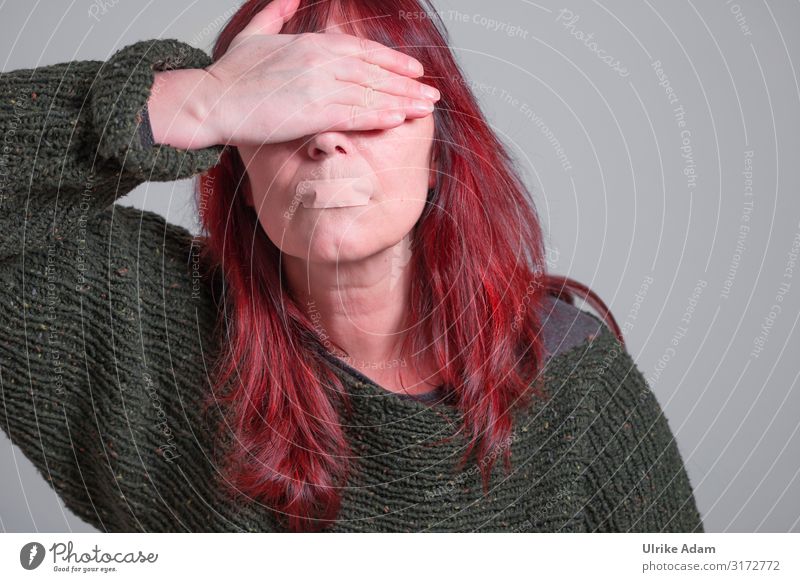 Protest against women violence - woman with red long hair covers her eyes and has a plaster on her mouth Closed eyes Front view portrait Neutral Background