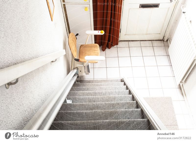 Automatic stair lift on staircase taking elderly people Lifestyle Design Flat (apartment) House (Residential Structure) Chair Human being Building Architecture