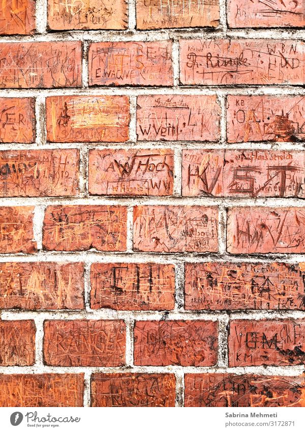 brick wall Environment Manmade structures Facade Sign Characters Digits and numbers Graffiti Orange Romance Past Colour photo Exterior shot