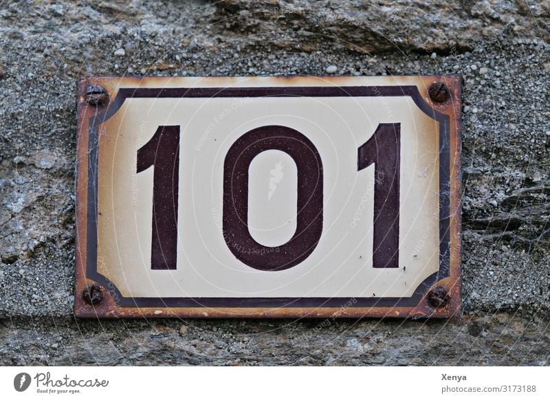 Shield 101 Wall (barrier) Wall (building) Facade Stone Metal Brown Gray White House number Digits and numbers Rust Tin plate sign Old Subdued colour