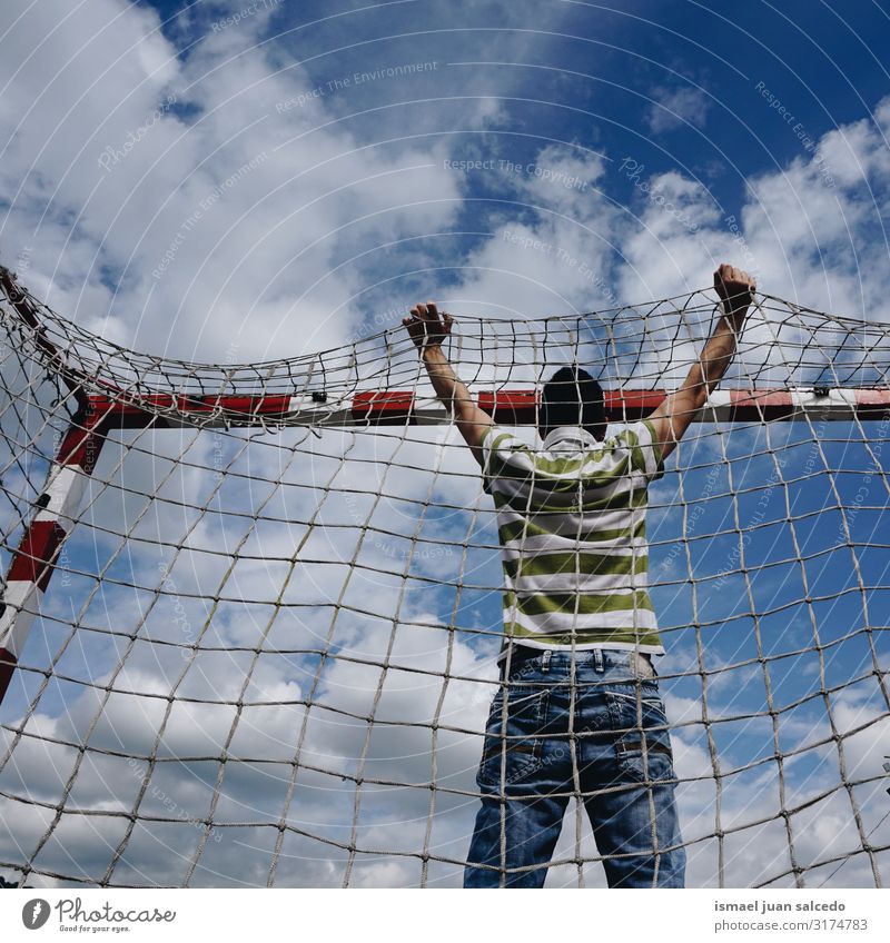 man and de soccer goal sports equipment Man Human being Goal Soccer Goal Sports equipment Rope Net Playing field Street Loneliness Freedom Clouds Sky