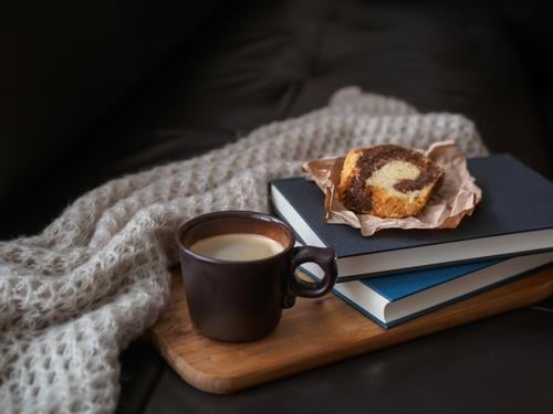Coffee break with cake Food Cake To have a coffee Beverage Hot drink Cup Lifestyle Living or residing Sofa Wool blanket Book Fragrance Relaxation Retro Moody