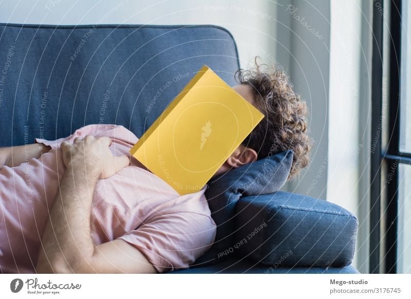 Man sleep on sofa with book cover his face Lifestyle Style Happy Face Relaxation Leisure and hobbies Reading House (Residential Structure) Sofa Business