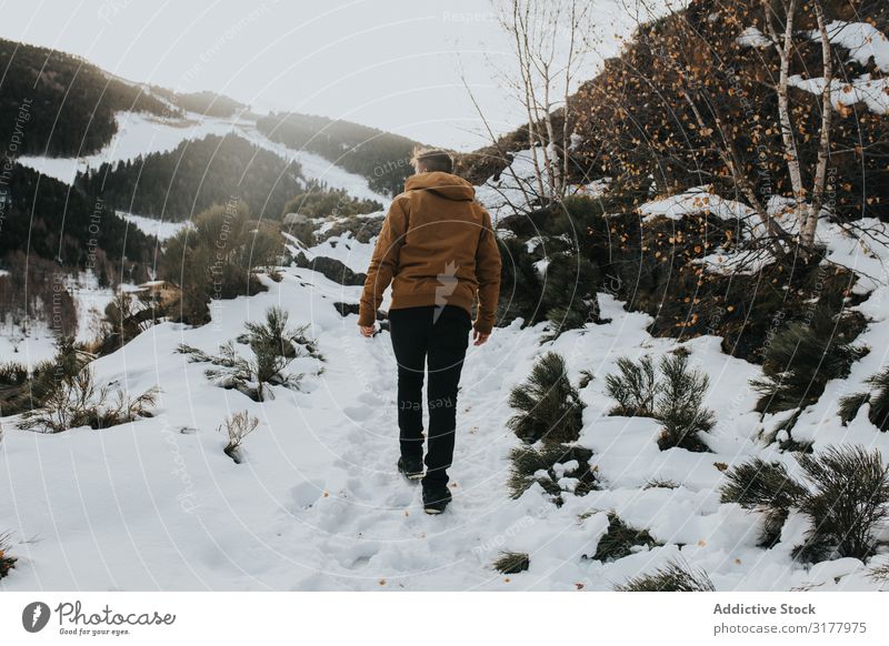 Man walking on footpath in snowy landscape Walking Snow Footpath Mountain Landscape Slope Nature Action hiker Day Movement Winter Weather traveler Going